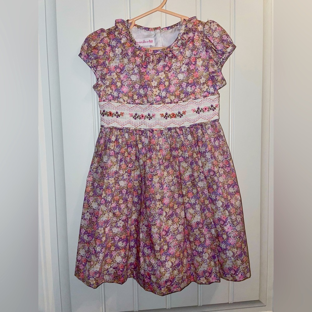 A beautiful never worn smocked dress with floral print